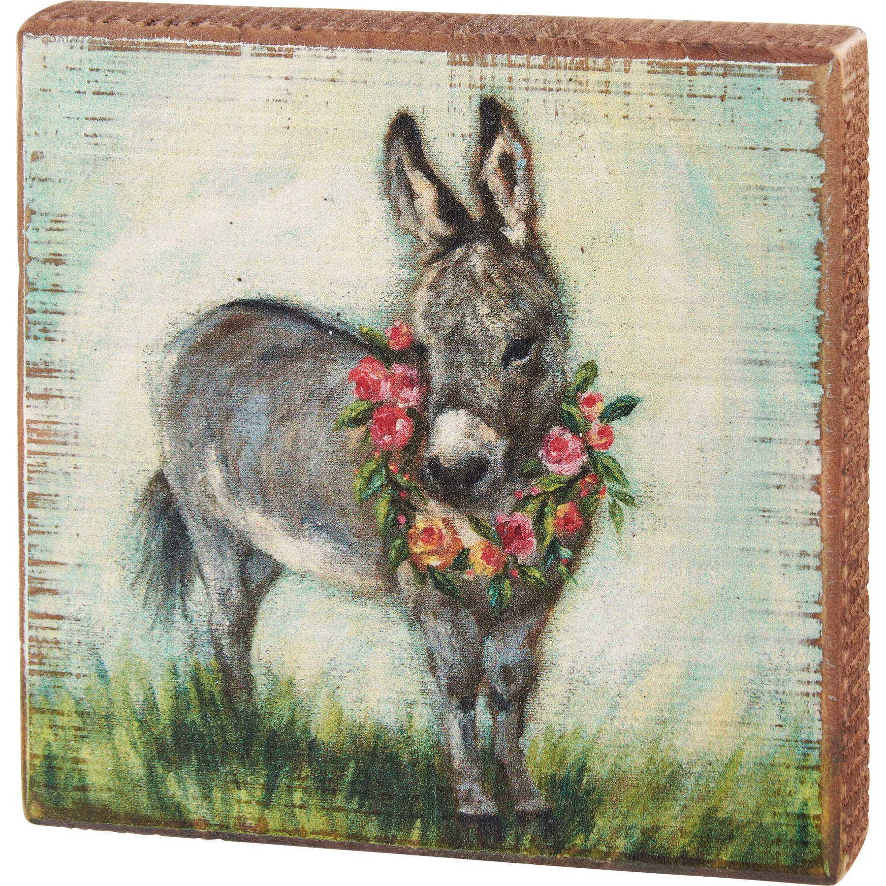 Decorative box picture with a donkey wearing a floral wreath on a wooden background