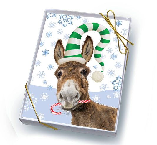 Christmas card with a donkey wearing a candy cane hat and holding a candy cane against a snowflake patterned background.