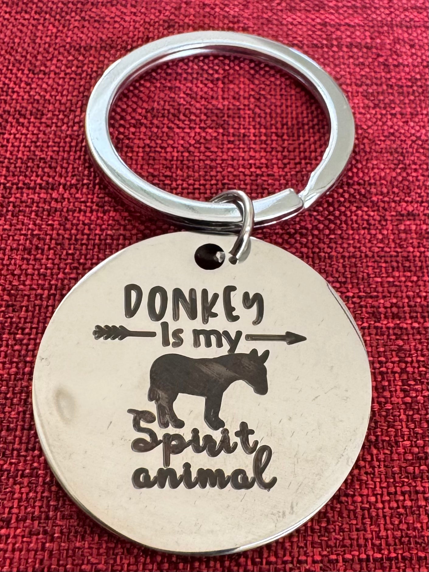 Keychain with 'Donkey is my spirit animal' text on a red background